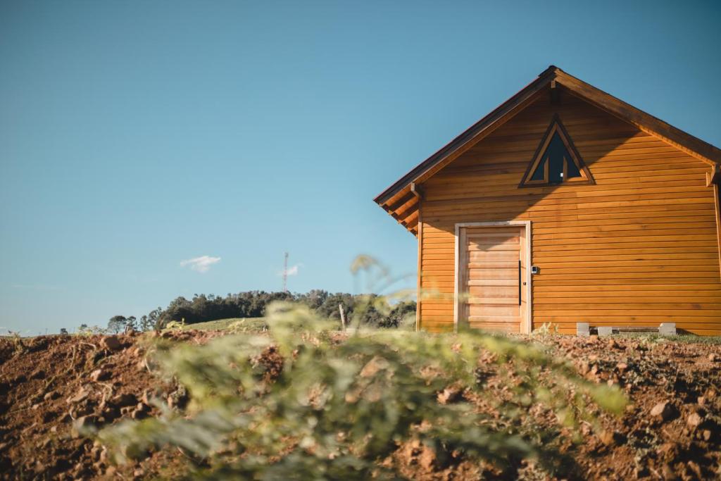 a wooden cabin on top of a hill at Chico Cabanas in Lajeado Grande