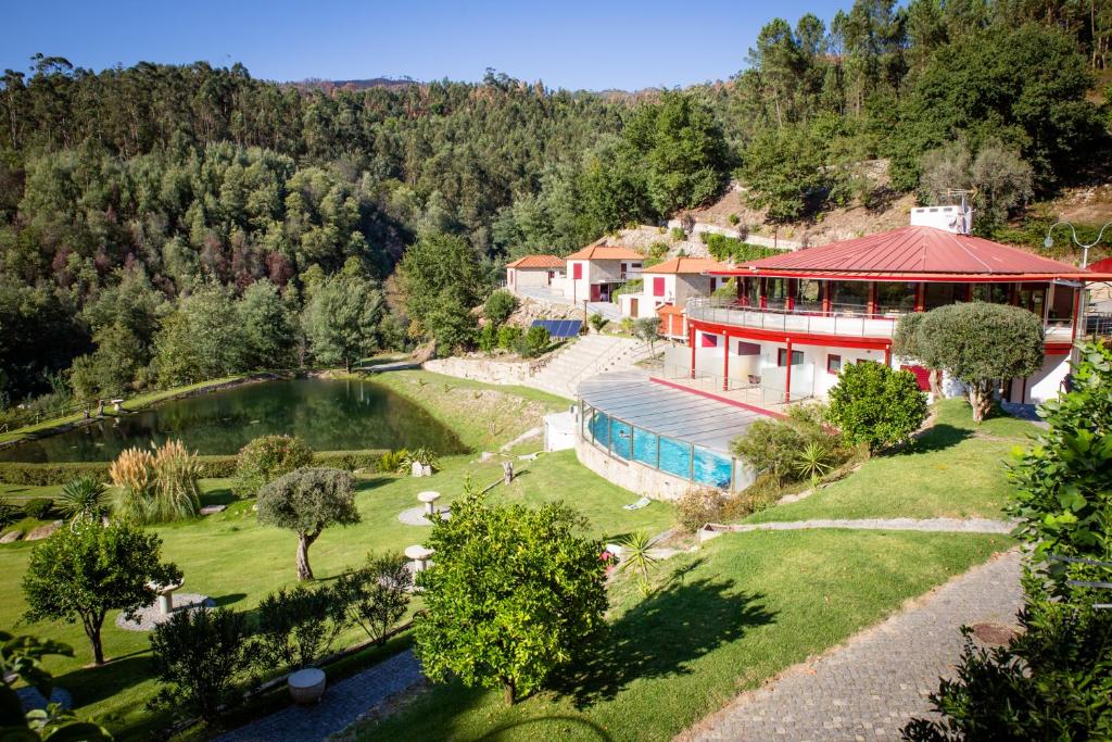 an aerial view of a house with a swimming pool at Quinta do Rio Gerês in Bouro