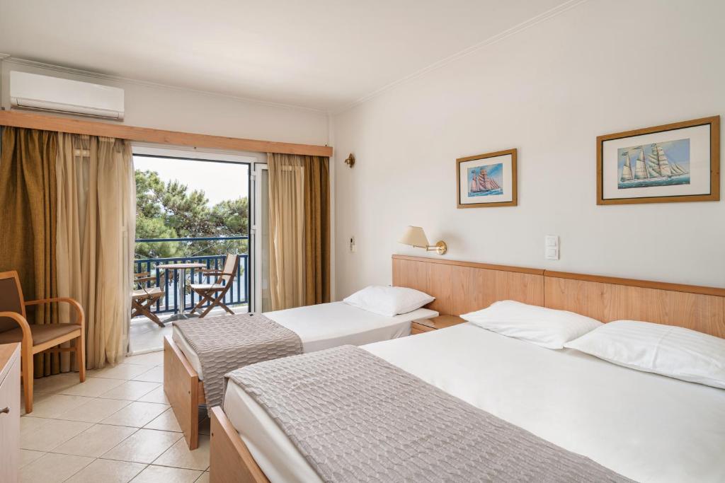 Postel nebo postele na pokoji v ubytování Danae Hotel