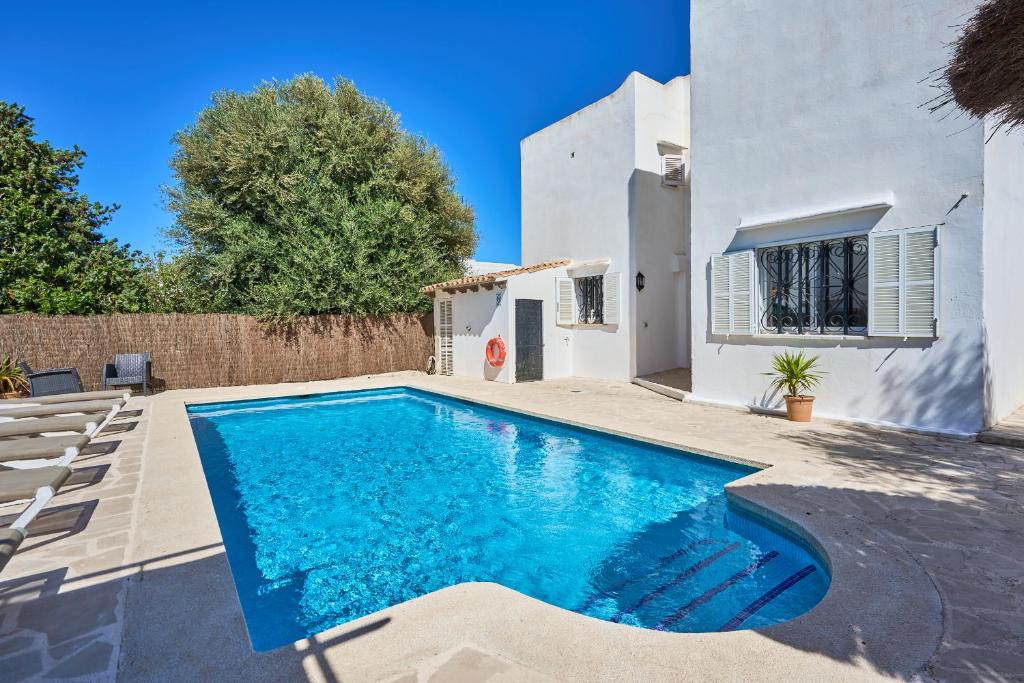 a swimming pool in the backyard of a house at Villa Fleming in Santanyi