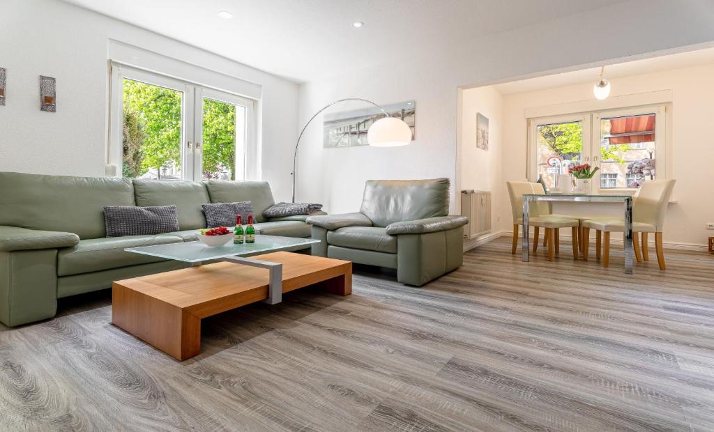 a living room with a couch and a table at Villa Helga- Fewo Morgensonne mit Terrasse, Kamin und 2 Schlafzimmer in Zinnowitz