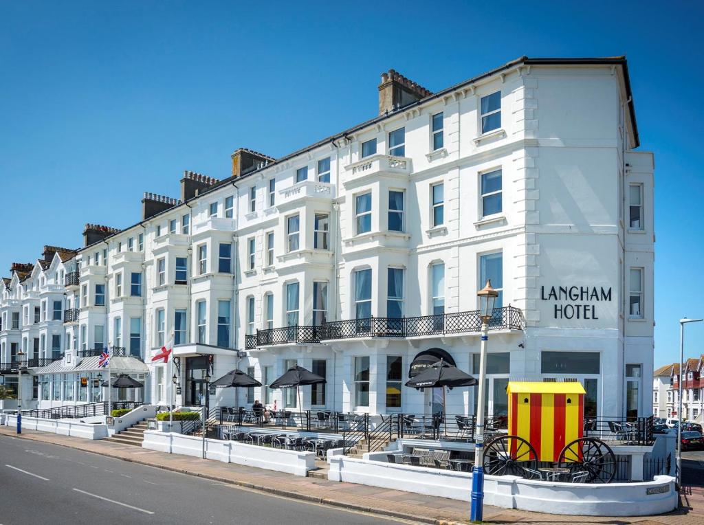 a large white building on the side of a street at Langham Hotel Eastbourne in Eastbourne