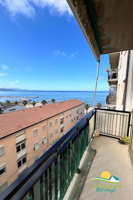 a balcony with a view of the ocean at Maremma Holidays-Gardenia Apartment in Follonica