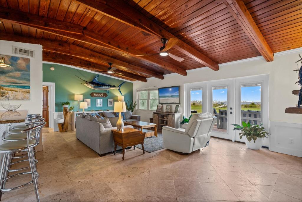 a large living room with a wooden ceiling at Sunset Vista Beach House in Pensacola Beach