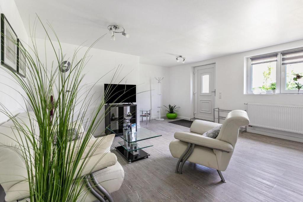 a living room with white furniture and a fireplace at Rømø in Galmsbüll