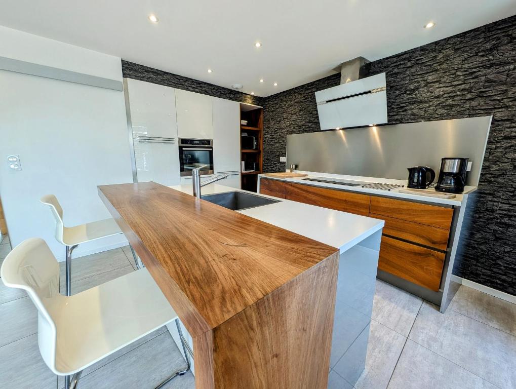 a kitchen with a wooden counter top in a room at La Chataigneraie in Châtenois