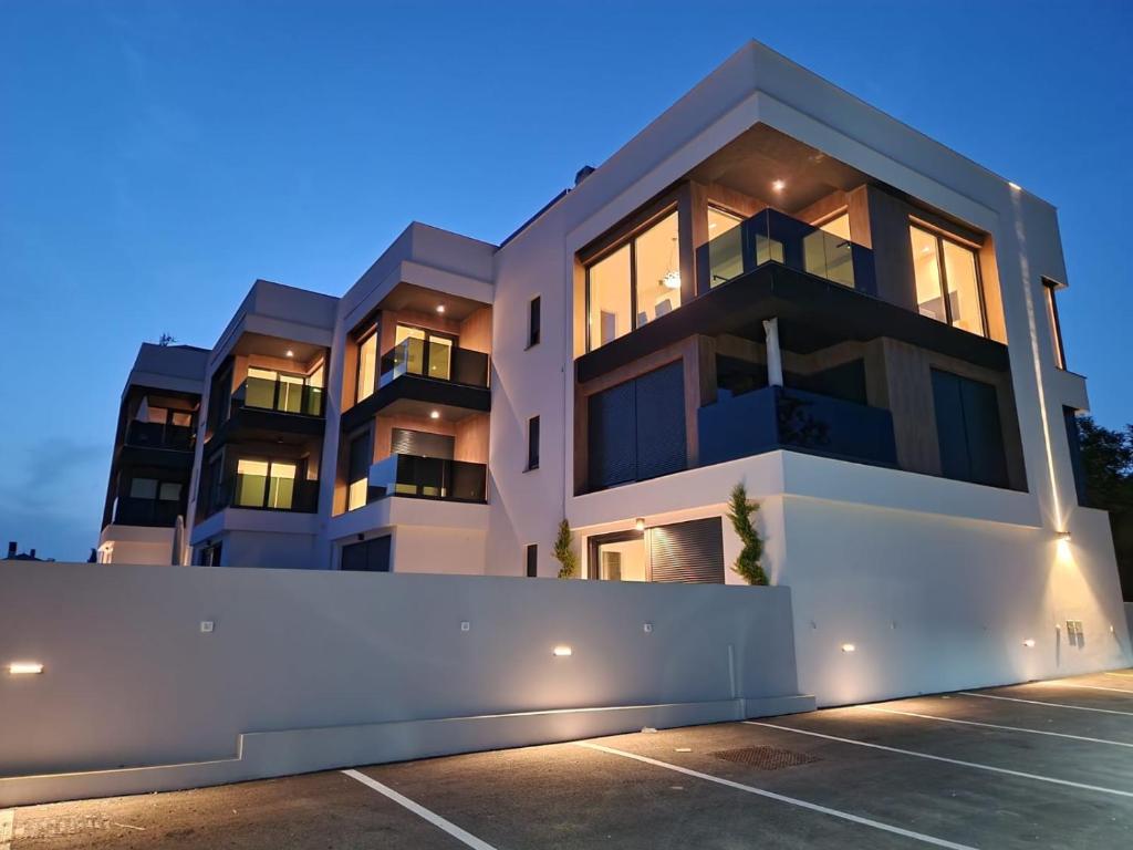 a building with a fence in front of it at HORIZON Privlaka3 in Privlaka