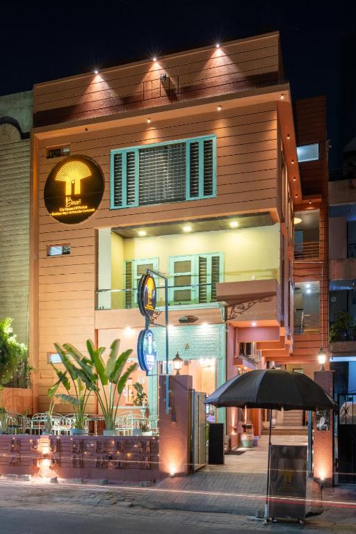 Hotel Baari The House of Fusion, a building with an umbrella in front of it at Baari The House of Fusion in Jaipur