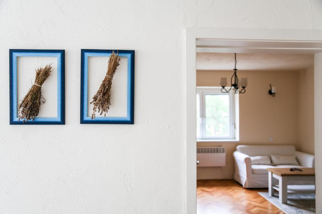 una sala de estar con 3 fotos de un pájaro en la pared en Angelina Vendégház, en Tarcal