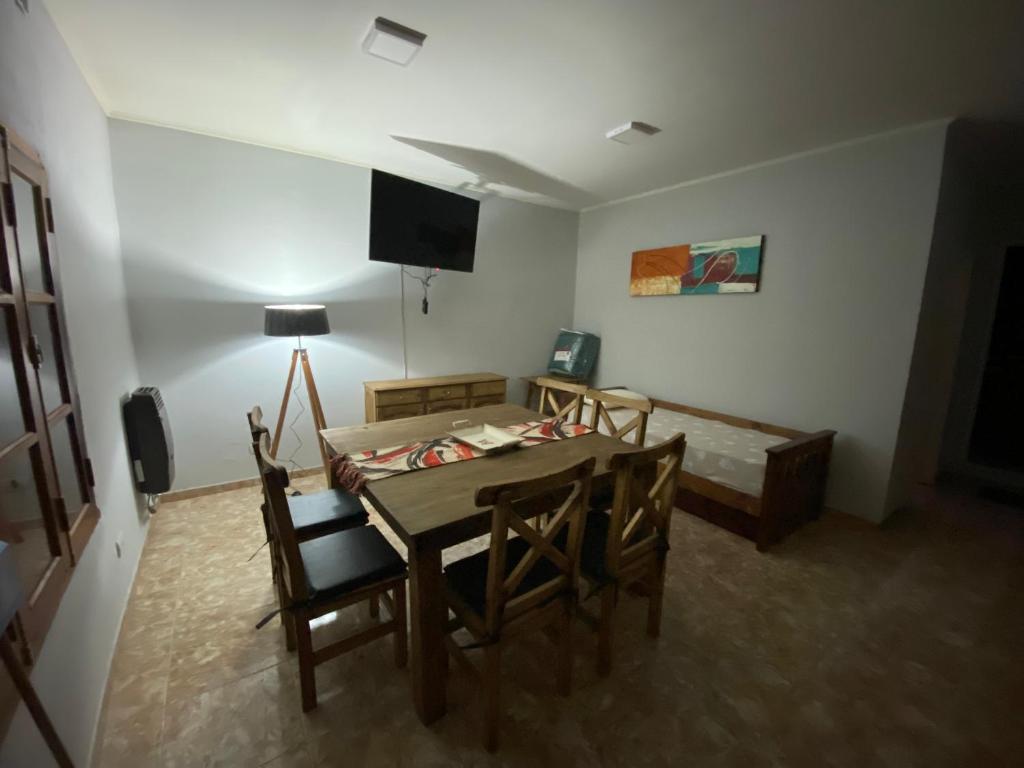 a room with a table and chairs and a television at Departamento la terminal in General Roca
