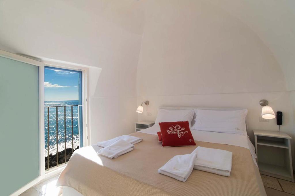 a bedroom with a large bed with a large window at B&B Finestra Sul Mare in Gallipoli
