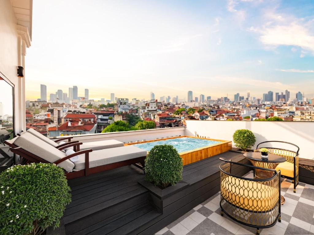 a rooftop deck with a pool and a view of the city at Minerva Premium Hotel in Hanoi