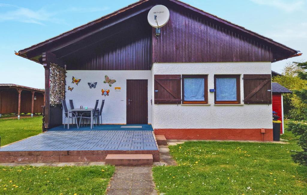 a house with a deck with a table on it at Ferienhaus 1 In Thalfang in Thalfang