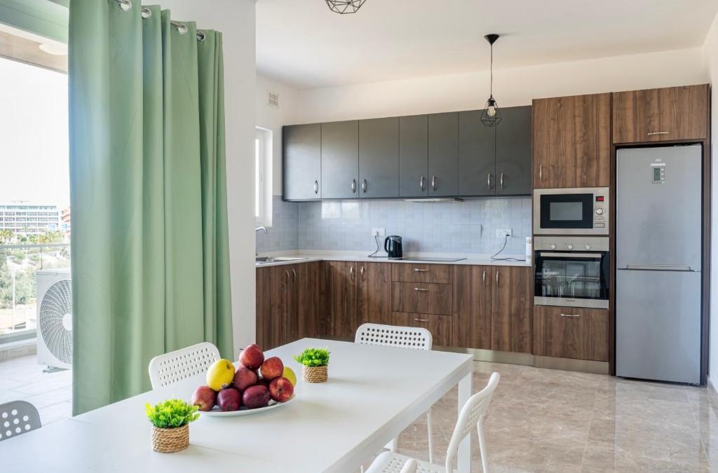 a kitchen with a table with a bowl of fruit on it at 3 bedroom apartment in Gudja in Gudja
