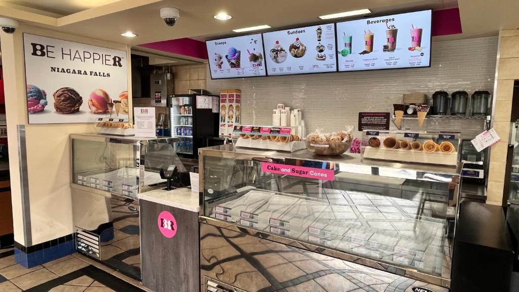a bakery with donuts on display in a store at Howard Johnson Plaza by Wyndham by the Falls Niagara Falls in Niagara Falls