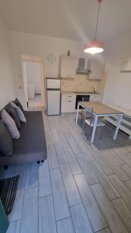 a kitchen with a couch and a table in a room at Borgolombardo Policlinico Eni San Giuliano M in San Giuliano Milanese