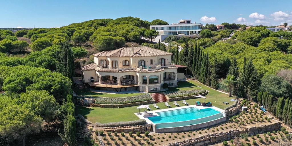 an aerial view of a mansion with a swimming pool at Casa Ceylan Luxury 8 Bed Villa with Sea, Golf & Mountain Views in Sotogrande