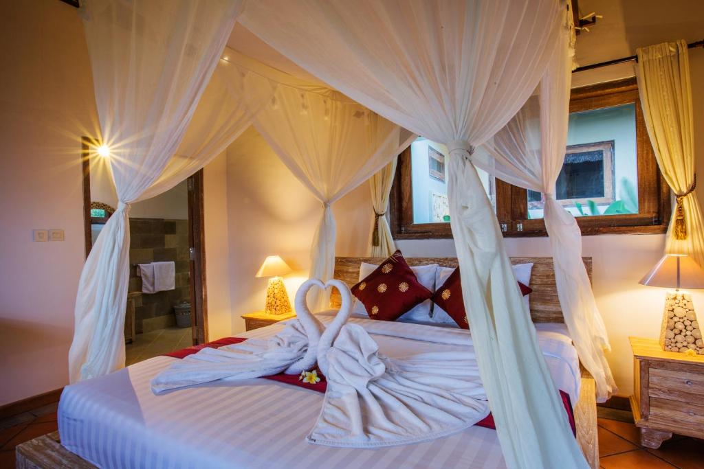 Postel nebo postele na pokoji v ubytování Ubud Luwih Nature Retreat