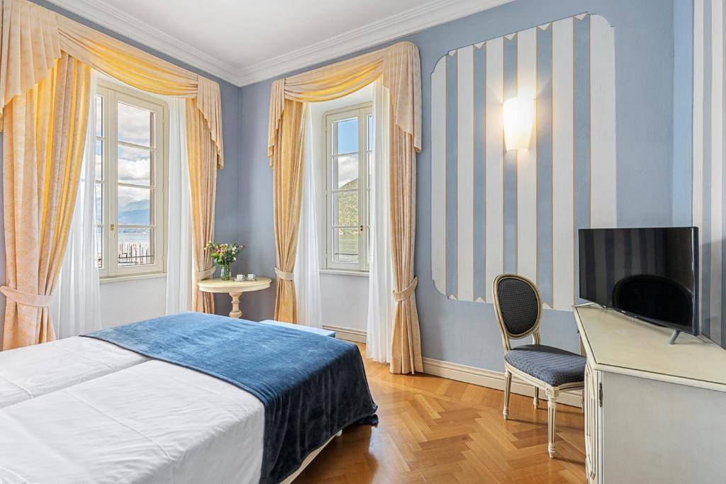 Postel nebo postele na pokoji v ubytování Hotel Cannobio