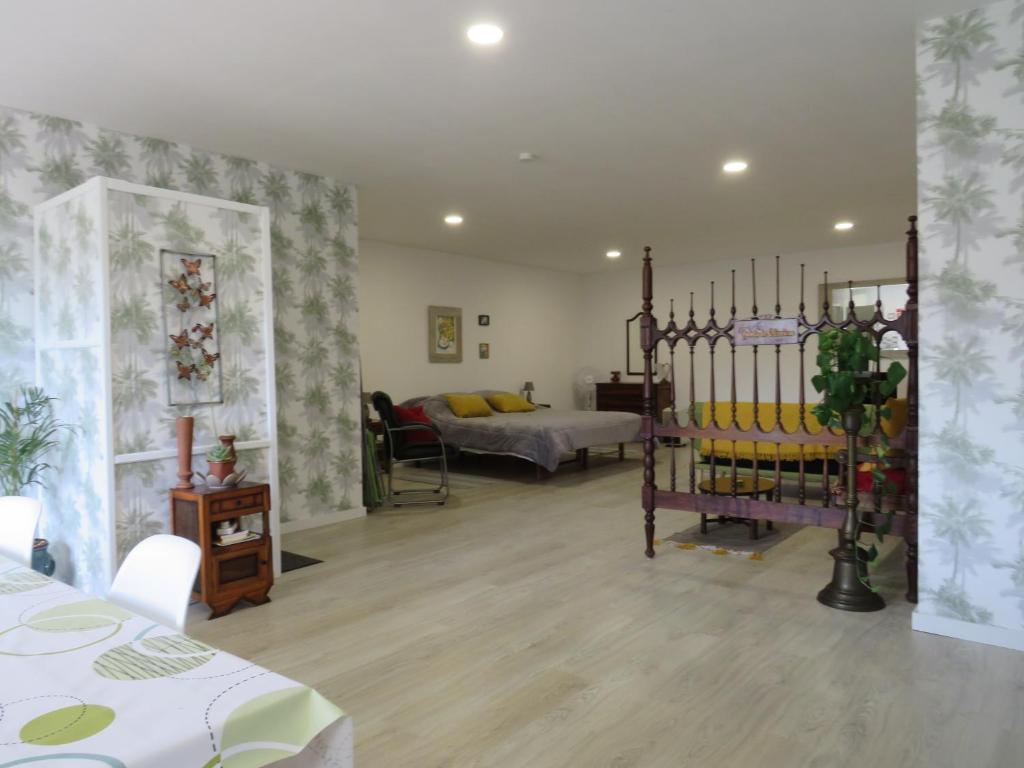 a room with a bedroom with a bed and a room with at Quinta De Oliveiras in Beco