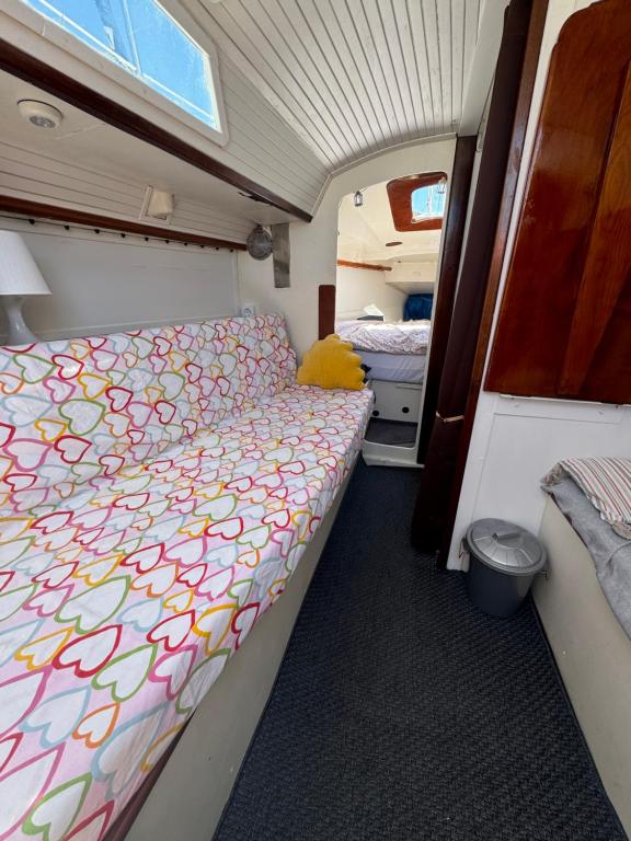 a camper with a bed in the middle of a room at Vive la experiencia de dormir acunado por las olas cerca de Barcelona in Castelldefels