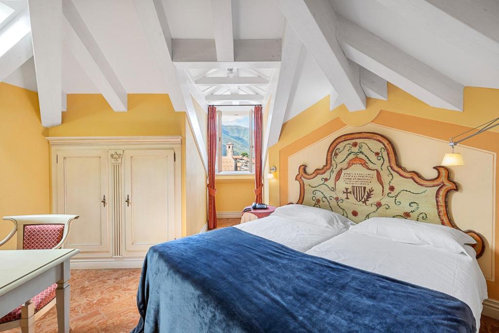 Postel nebo postele na pokoji v ubytování Hotel Cannobio