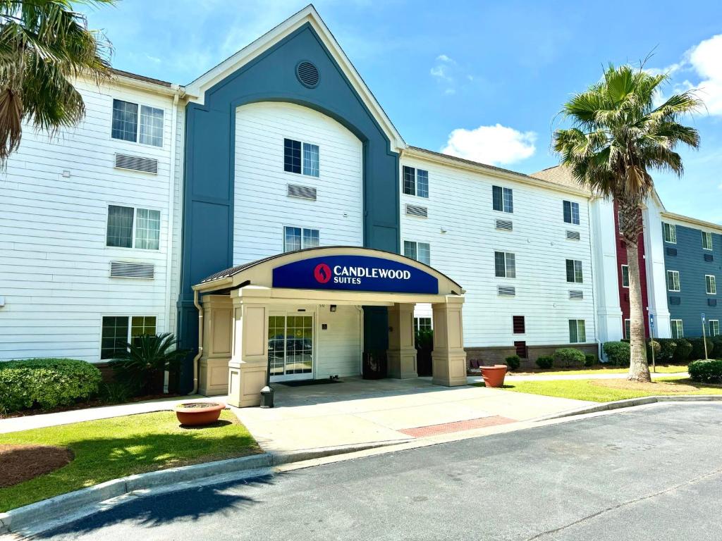 a building with a sign that reads cambridge inn at Candlewood Suites Savannah Airport, an IHG Hotel in Savannah