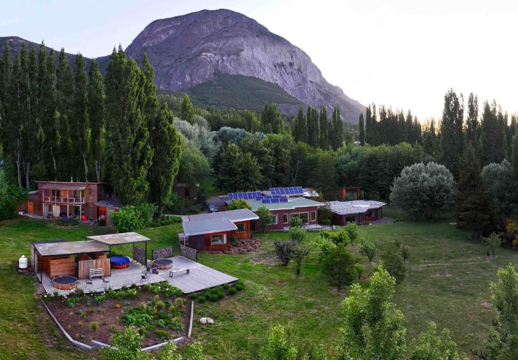 una vista aérea de una casa en un campo con una montaña en Patagonia House, en Coyhaique