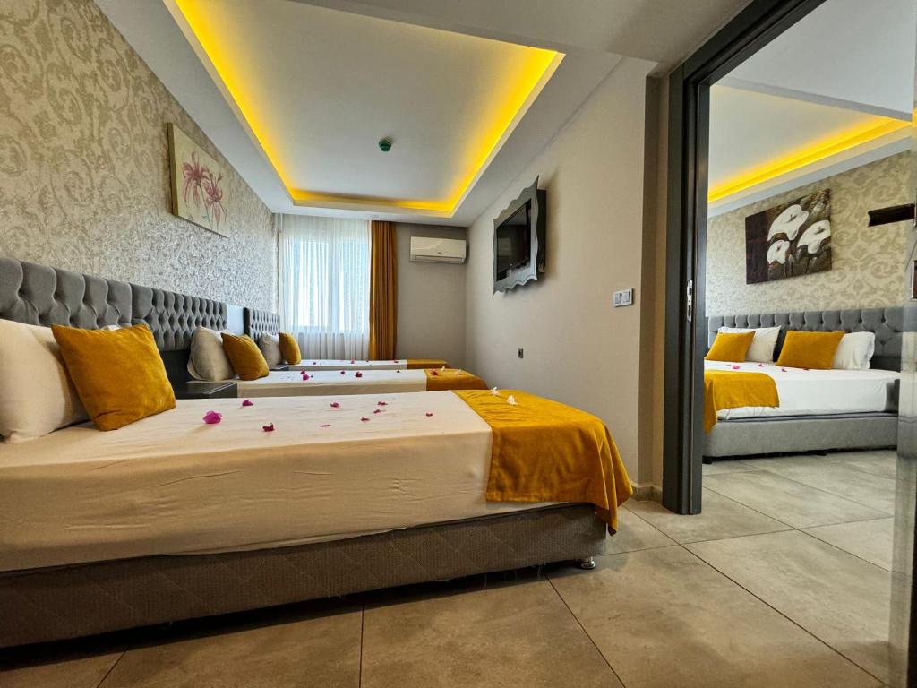 A bed or beds in a room at ERDEM HOTEL