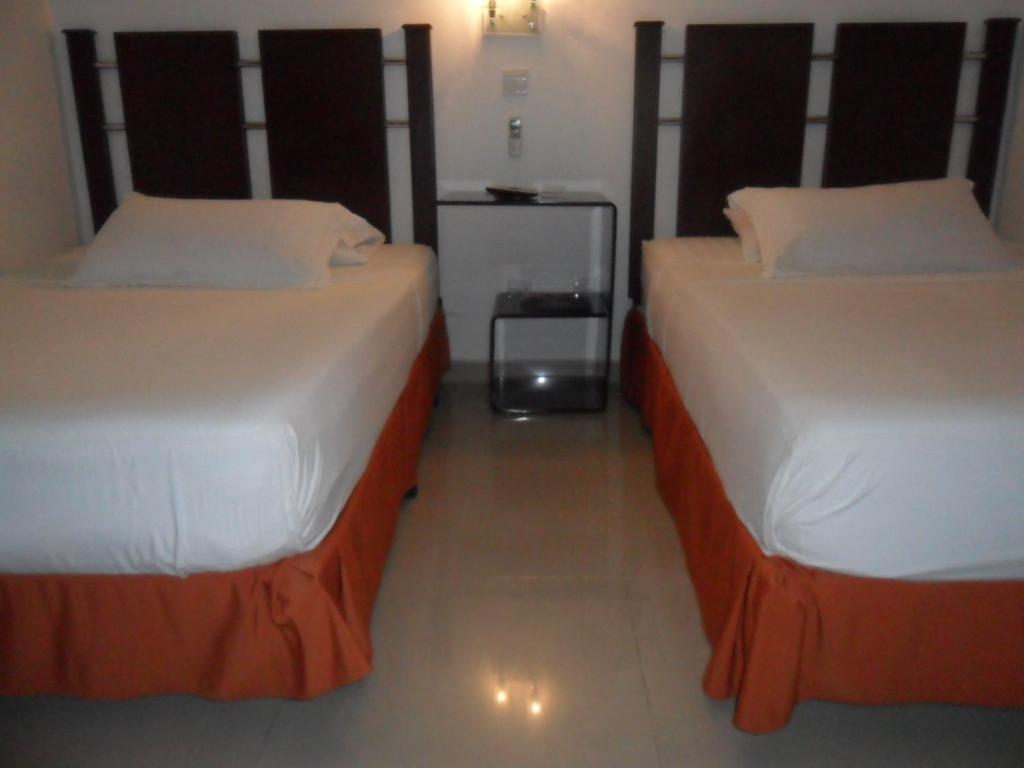 Postel nebo postele na pokoji v ubytování Hotel Calima Real