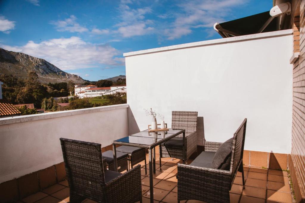 a patio with a table and chairs on a balcony at Casadiella, apartamento con terraza y piscina, playa 3 km VUT-5630-AS in Llanes