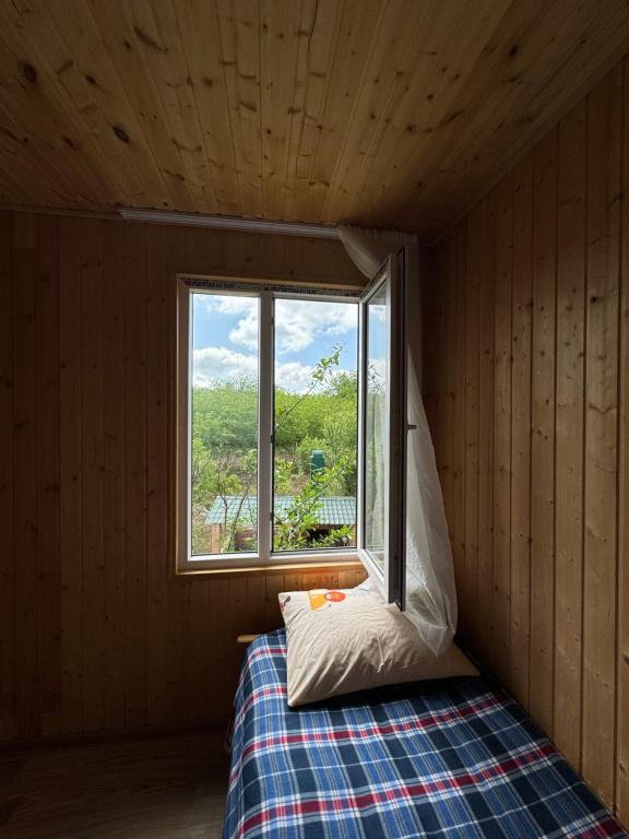Cette petite chambre comprend un lit et une fenêtre. dans l'établissement Guesthouse SANIKO, à Martvili