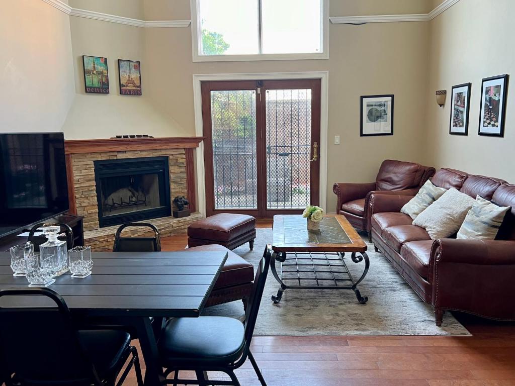 a living room with a couch and a fireplace at 4 bedroom in Best Location Parking Fireplace Back Yard Home office Pets Welcome in Chicago