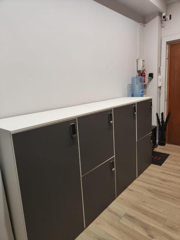 a kitchen with grey cabinets and a white counter top at Cuore Napoli Centro in Naples