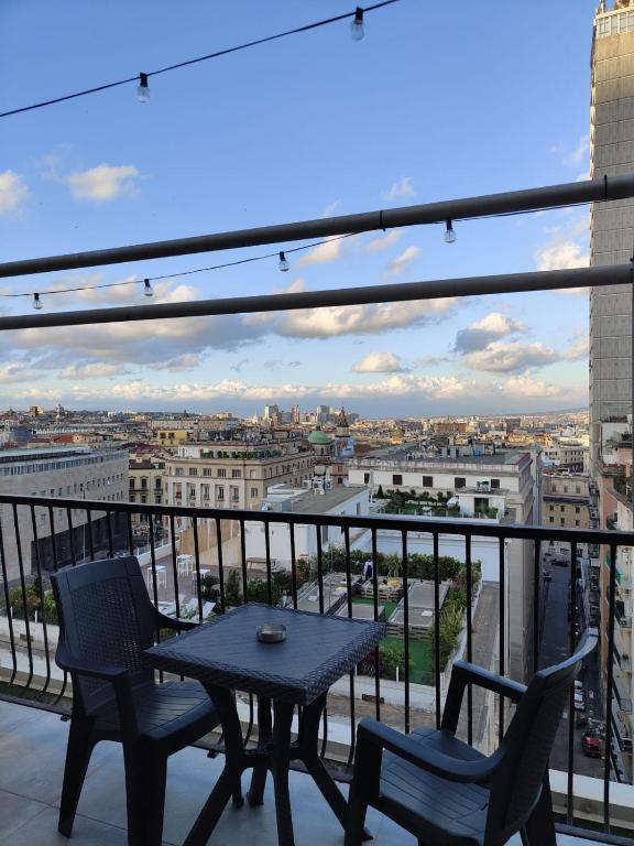 a table and chairs on a balcony with a view at Cuore Napoli Centro in Naples
