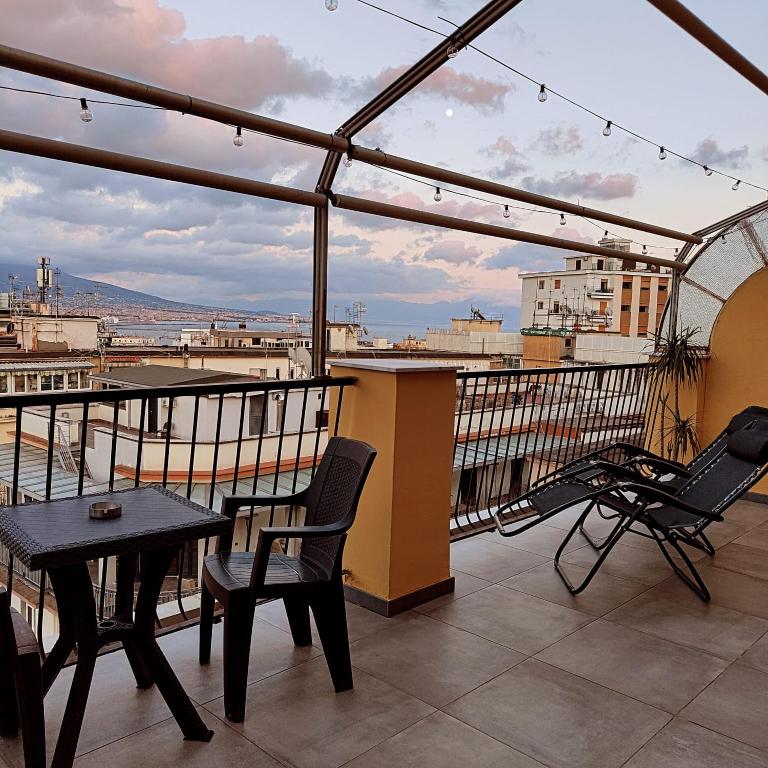 a patio with a table and chairs on a balcony at Cuore Napoli Centro in Naples