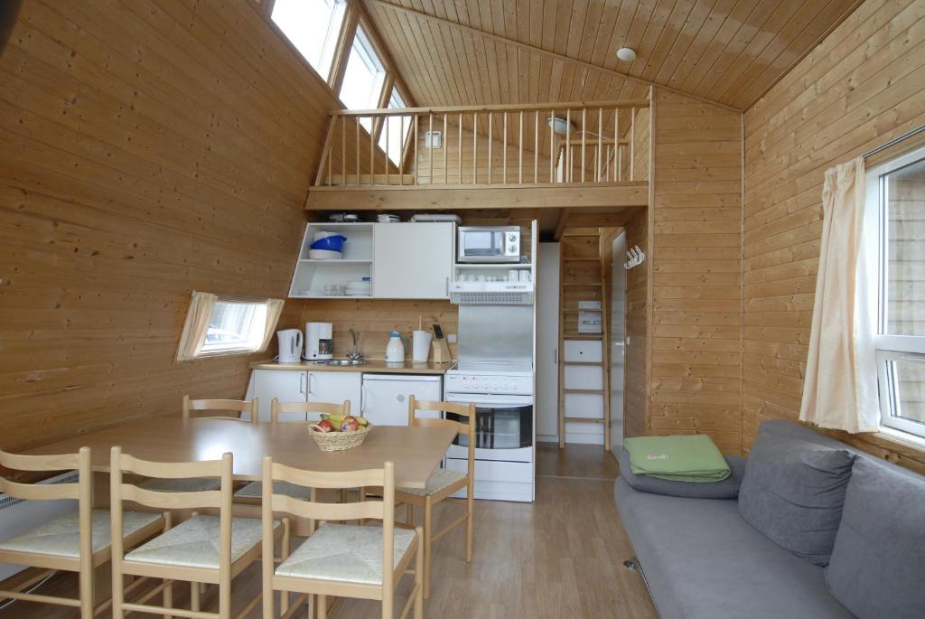 a kitchen and dining room of a tiny house at Dancamps Kolding City in Kolding