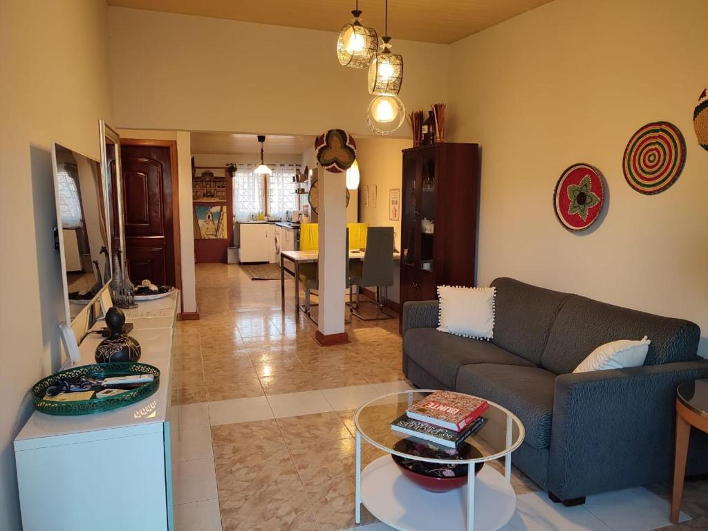 a living room with a couch and a table at Oheneba Tema - Luxury Hot -Tub Retreat with Wi-Fi in Tema