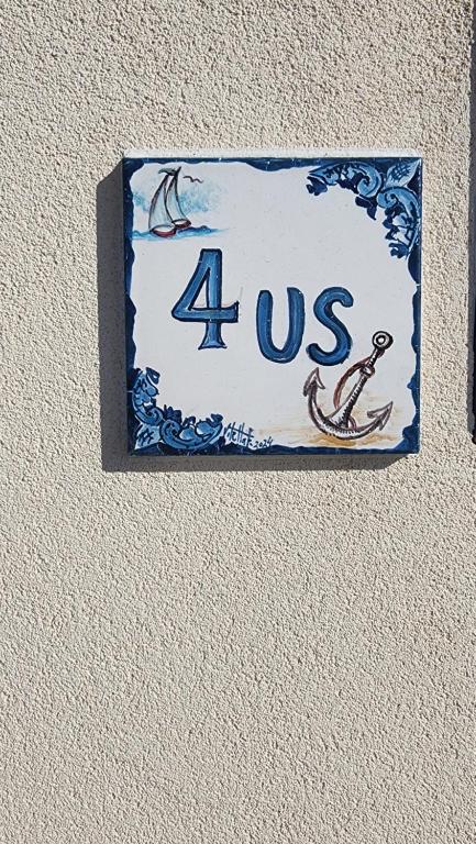 a sign on a wall that says us at 4US: A cosy glamour stay on the sea 4YOU! in Vibo Valentia Marina
