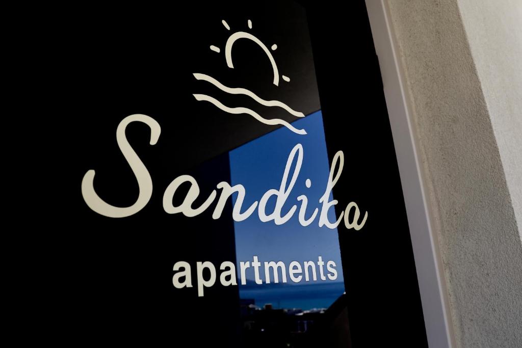 赫索尼索斯的住宿－Sandika apartments，窗口上波浪餐厅标志