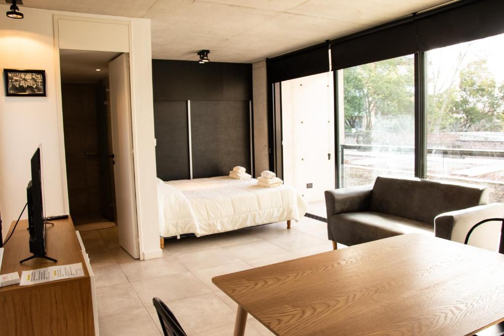 una sala de estar con una cama y un sofá en Monoambiente 2do piso de calidad en Pichincha, en Rosario