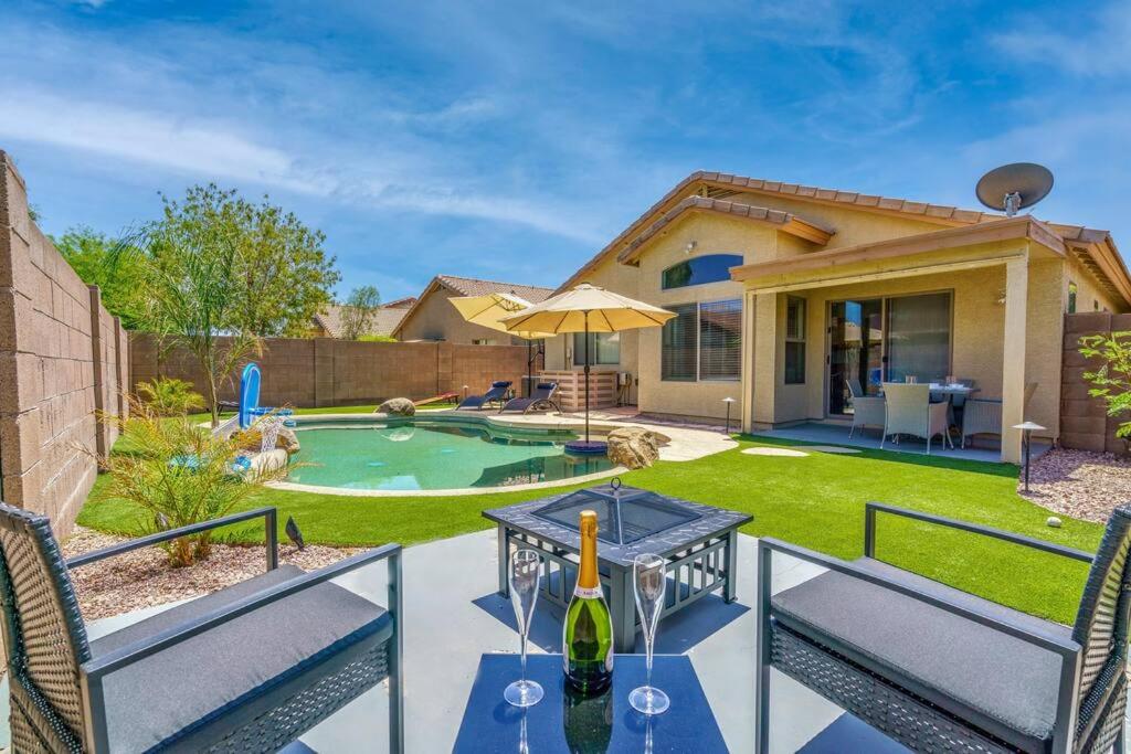 a patio with a table with a bottle of wine at Great location near shopping & entertainment in Litchfield Park
