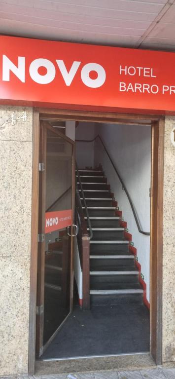 a sign for a hotel baroniappe with a staircase at Novo Hotel Barro Preto in Belo Horizonte