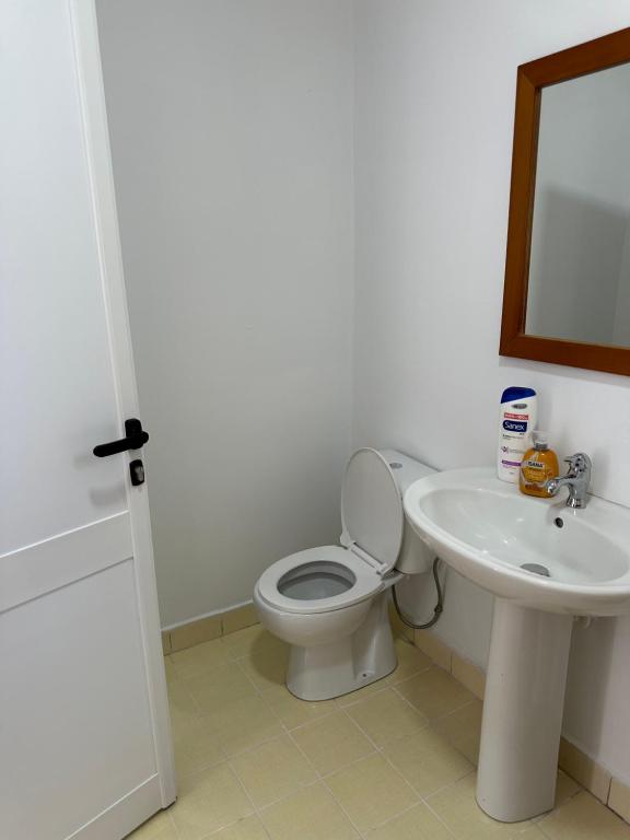 a bathroom with a toilet and a sink at Sunny Rentals in Vlorë
