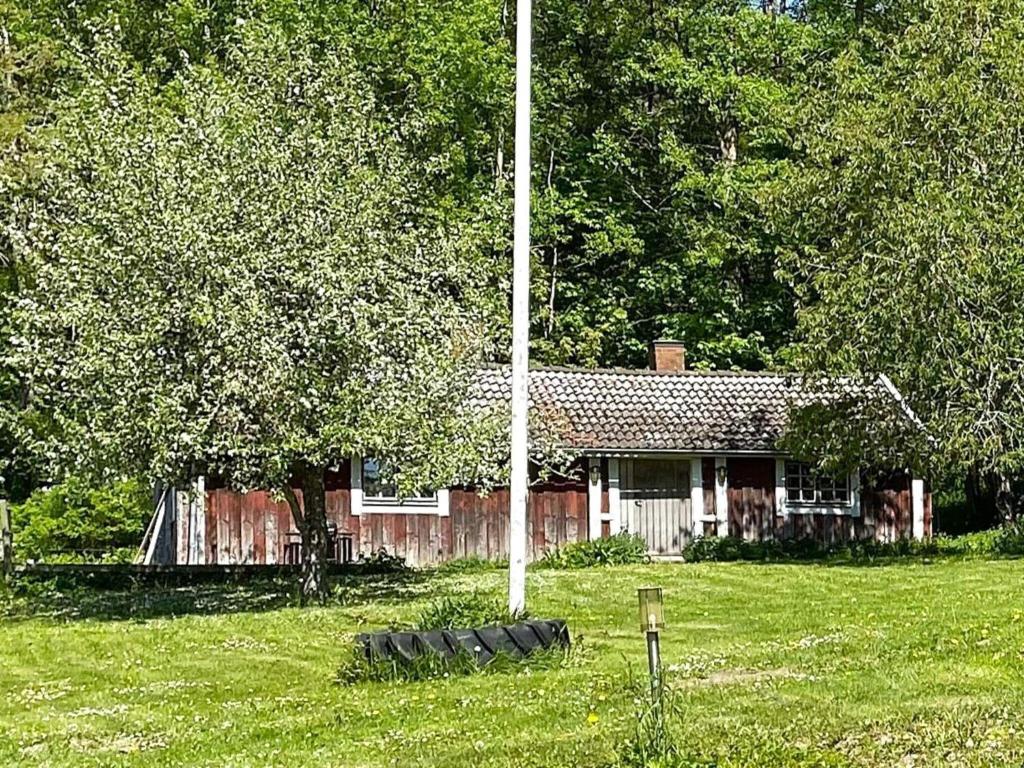 a house with a group of tires in front of it at 4 person holiday home in ANNEBY-By Traum in Aneby