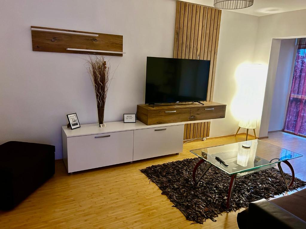 a living room with a flat screen tv on a cabinet at Elina apartament in Drobeta-Turnu Severin