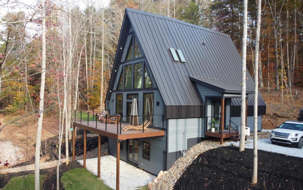 a tiny house in the woods with a deck at Lakefront Keowee Luxury Cottages 127 in Seneca