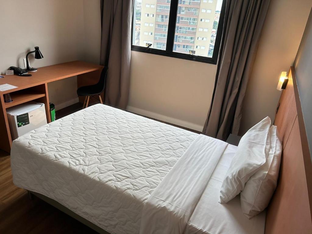 מיטה או מיטות בחדר ב-Comfort Hotel Presidente Prudente