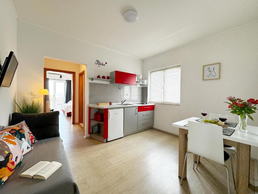 a living room with a couch and a table and a kitchen at Hvar Sunny hill in Hvar