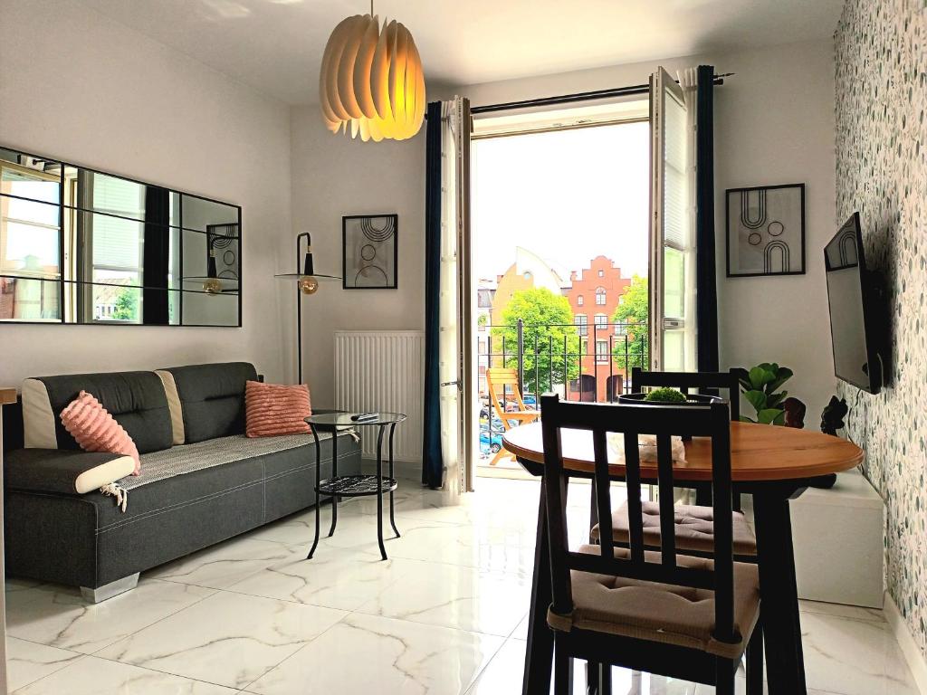 a living room with a couch and a table at Apartament Ania Stare Miasto in Elblag